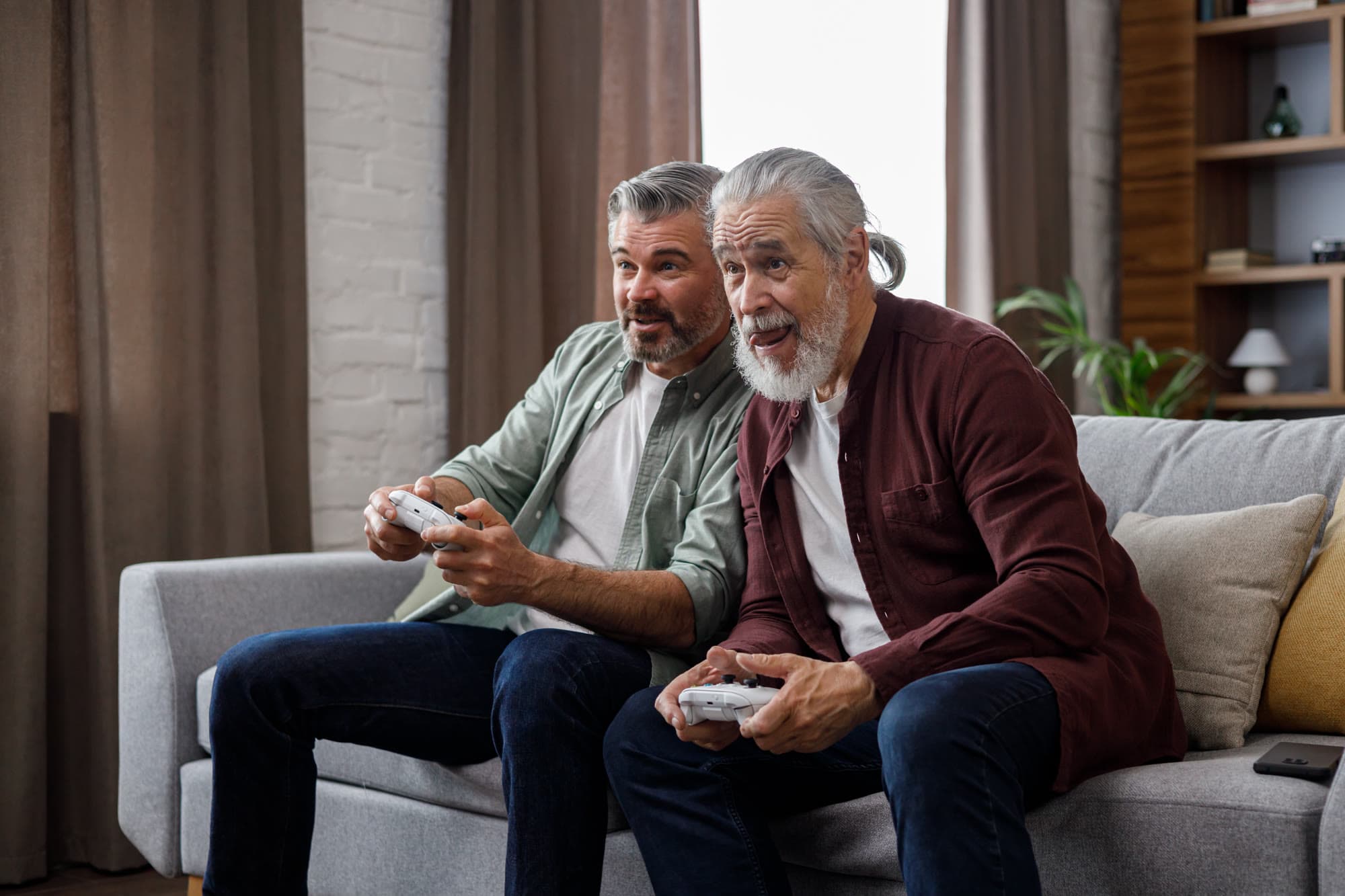 Two men laughing while playing video games